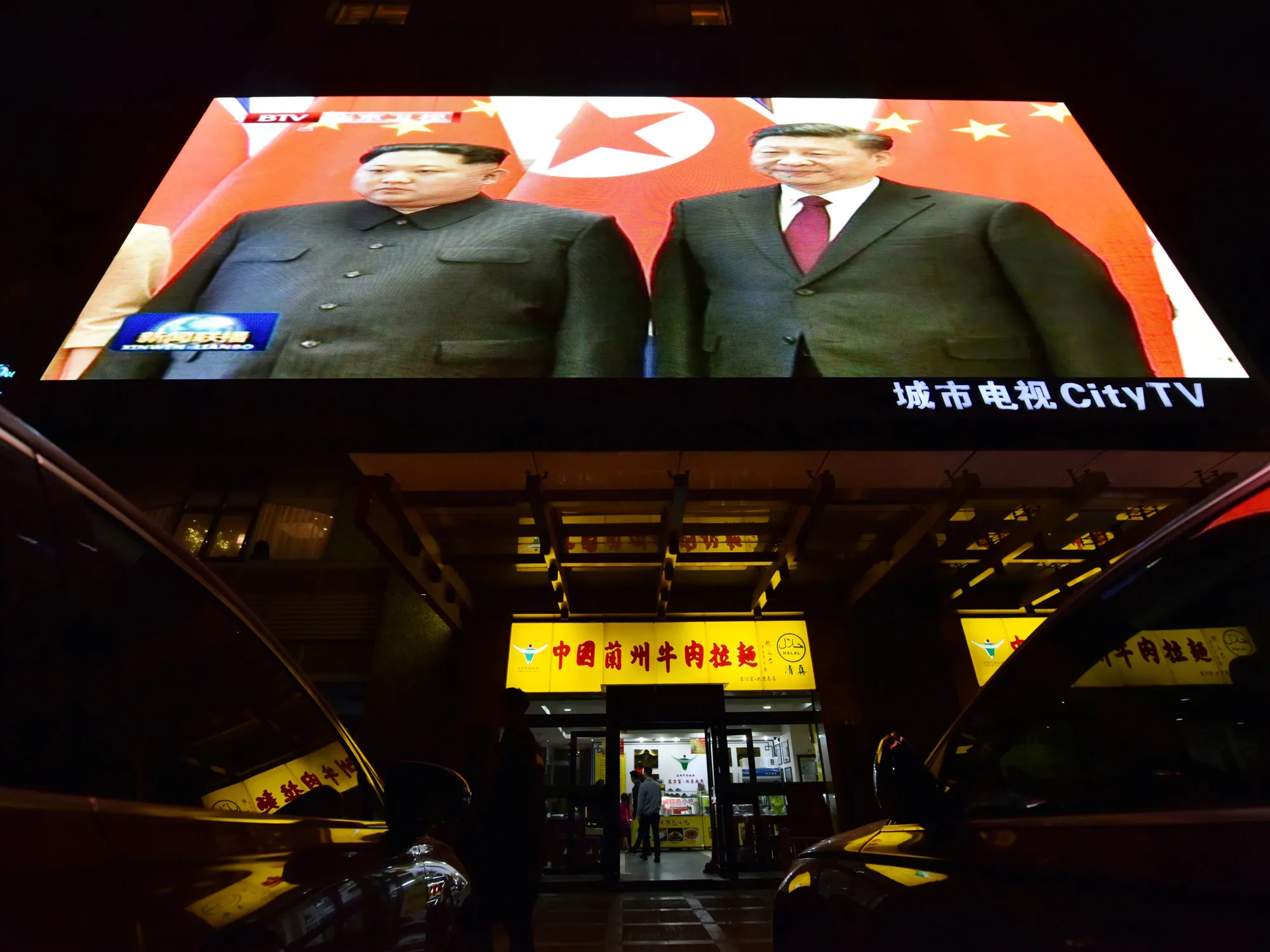 Newscast showing the 2018 meeting of Xi Jinping and Kim Jon-Un.