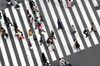 Pedestrians cross a road in the Ginza area in Tokyo, Japan, on Saturday, Feb. 15, 2020. Japan's economy likely suffered its biggest contraction since 2014 at the end of last year leaving it in a vulnerable state, as fallout from China's viral outbreak threatens to turn a one-quarter-slump into a recession.