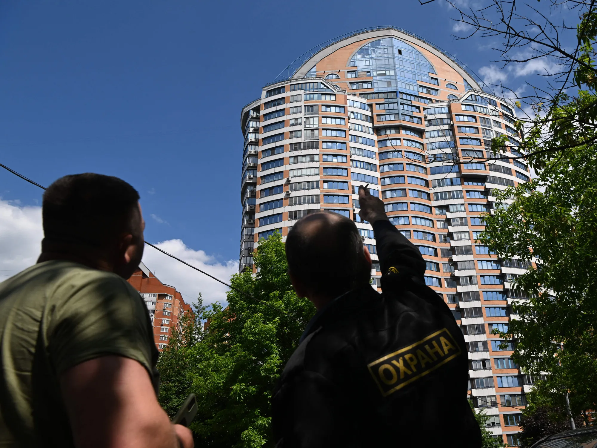A security guard points towards an apartment building after a reported drone attack in Moscow on May 30.