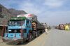 A man walks past Afghan’s trucks parked along a road near the closed Pakistan-Afghanistan border on March 16.