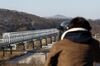 A visitor using binoculars looks north at the Imjingak Pavilion near the Demilitarized Zone (DMZ) in Paju, South Korea, on Monday, Dec. 26, 2011.