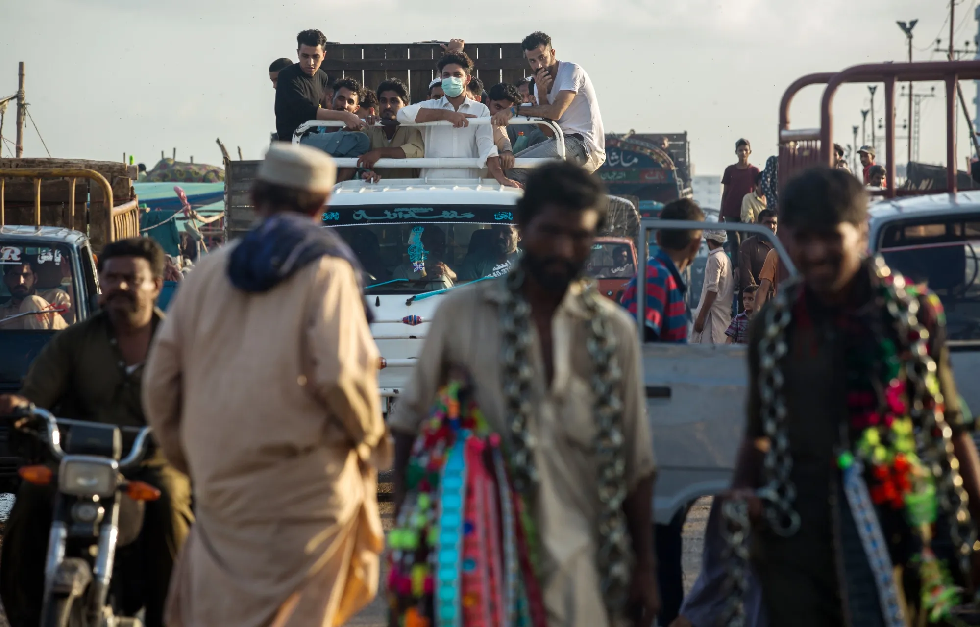 People attend a cattle market ahead of the Eid holidays in Karachi on July 28, with most seen not wearing masks.