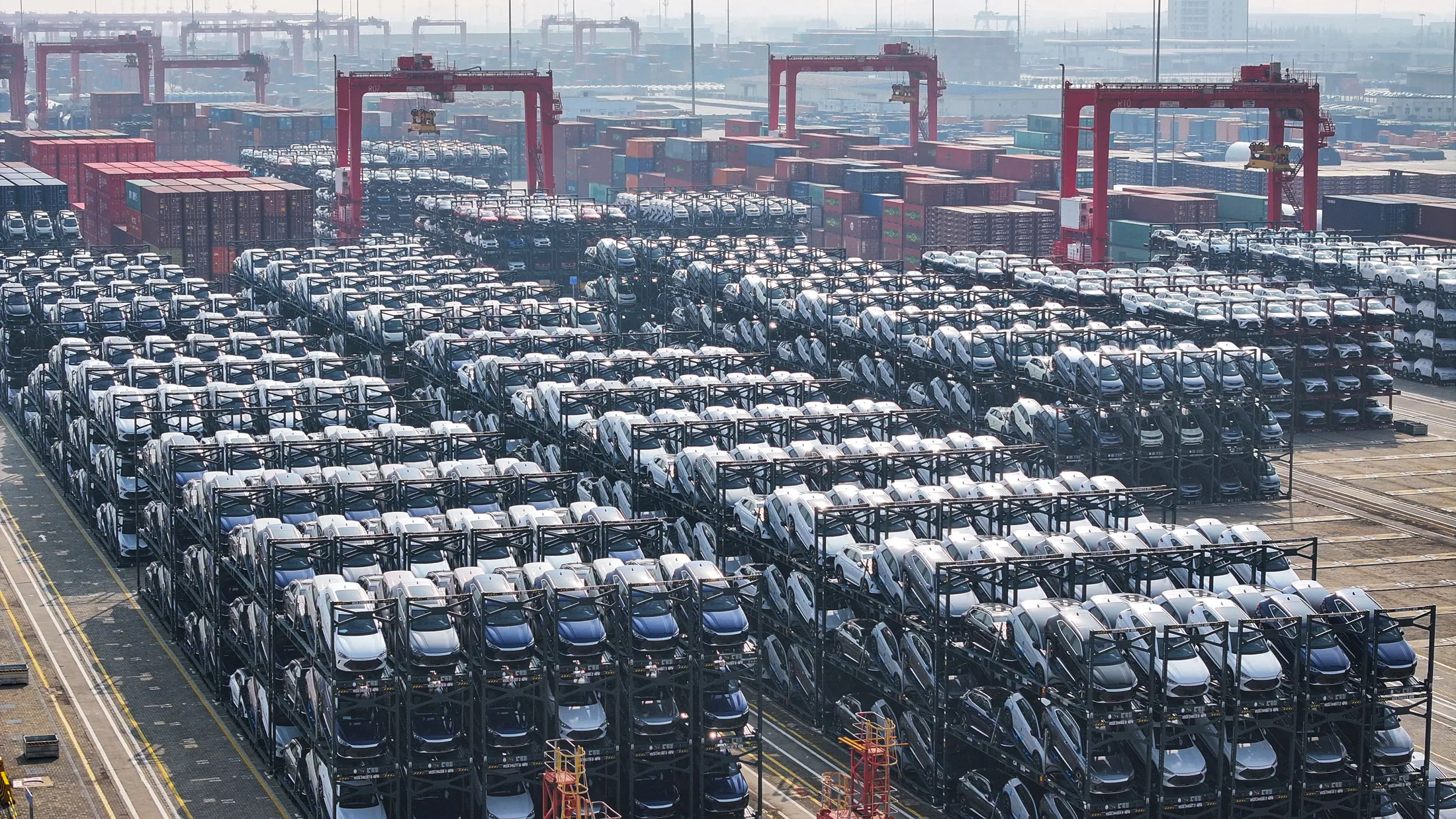 Electric vehicles await transport at a port in Suzhou, China.