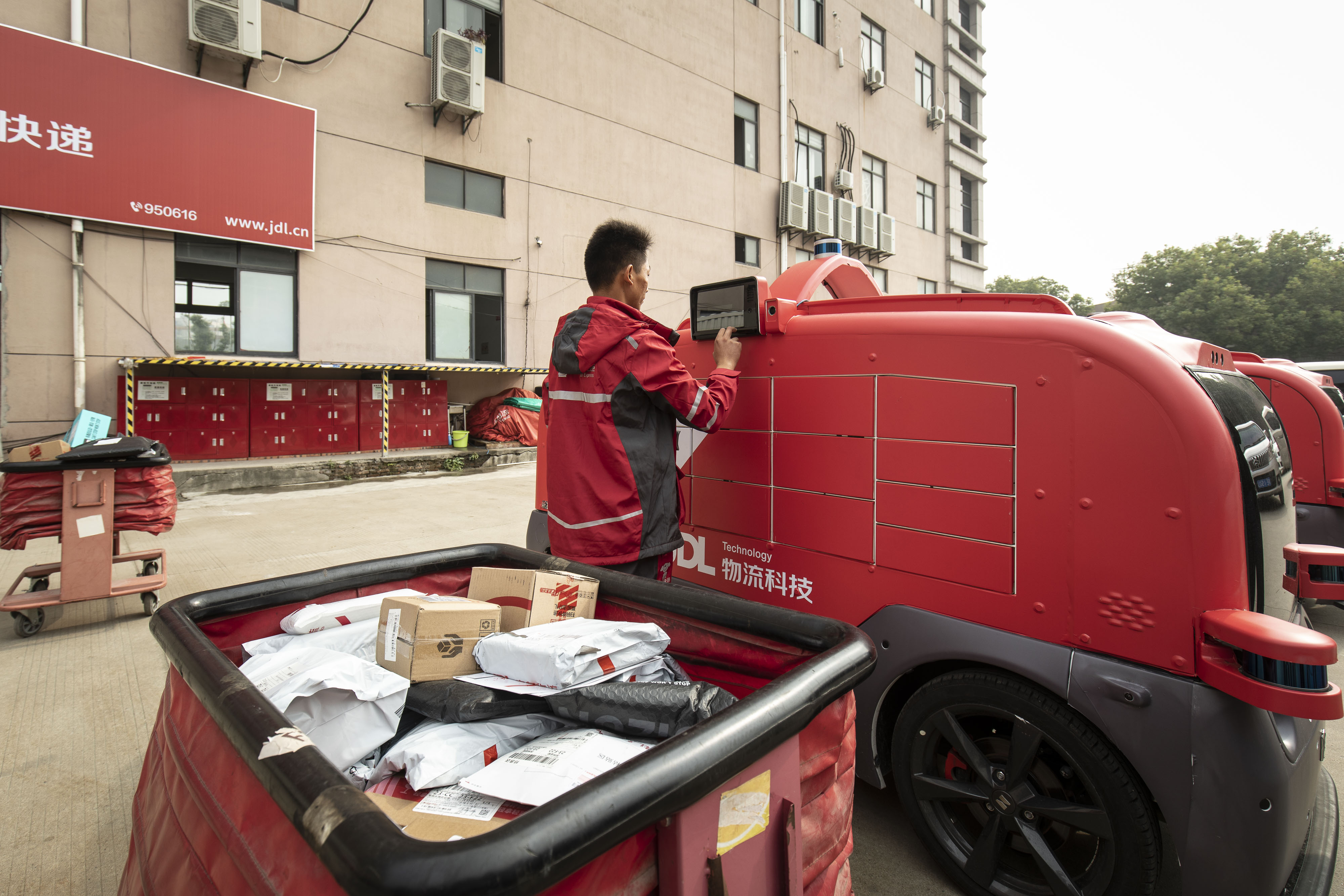 A driver for JD.com Inc.'s Luxury Express delivery service opens