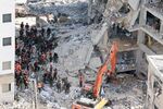 Israeli rescuers search through the rubble at the site of an overnight Iranian missile strike in Bat Yam on June 15, 2025.
