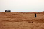 A Saudi woman walks in the desert, in Thumama, Saudi Arabia on Nov. 7, 2008