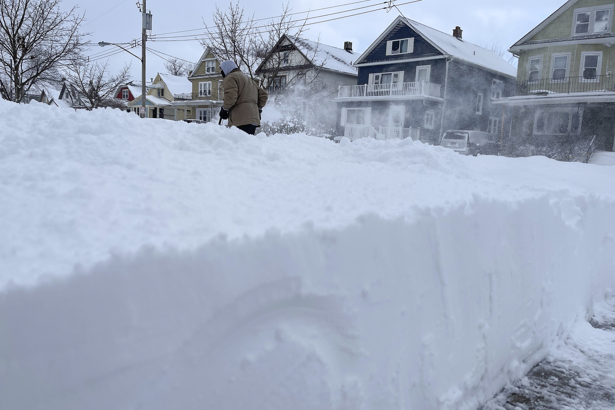 A resident clears snow near their&nbsp;property in Buffalo, New York, on Dec. 25.