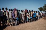 Refugees who fled the Ethiopia's Tigray conflict wait in&nbsp;line for&nbsp;food distribution at the Um Raquba refugee camp in Sudan's eastern Gedaref state on Dec. 12, 2020.&nbsp;