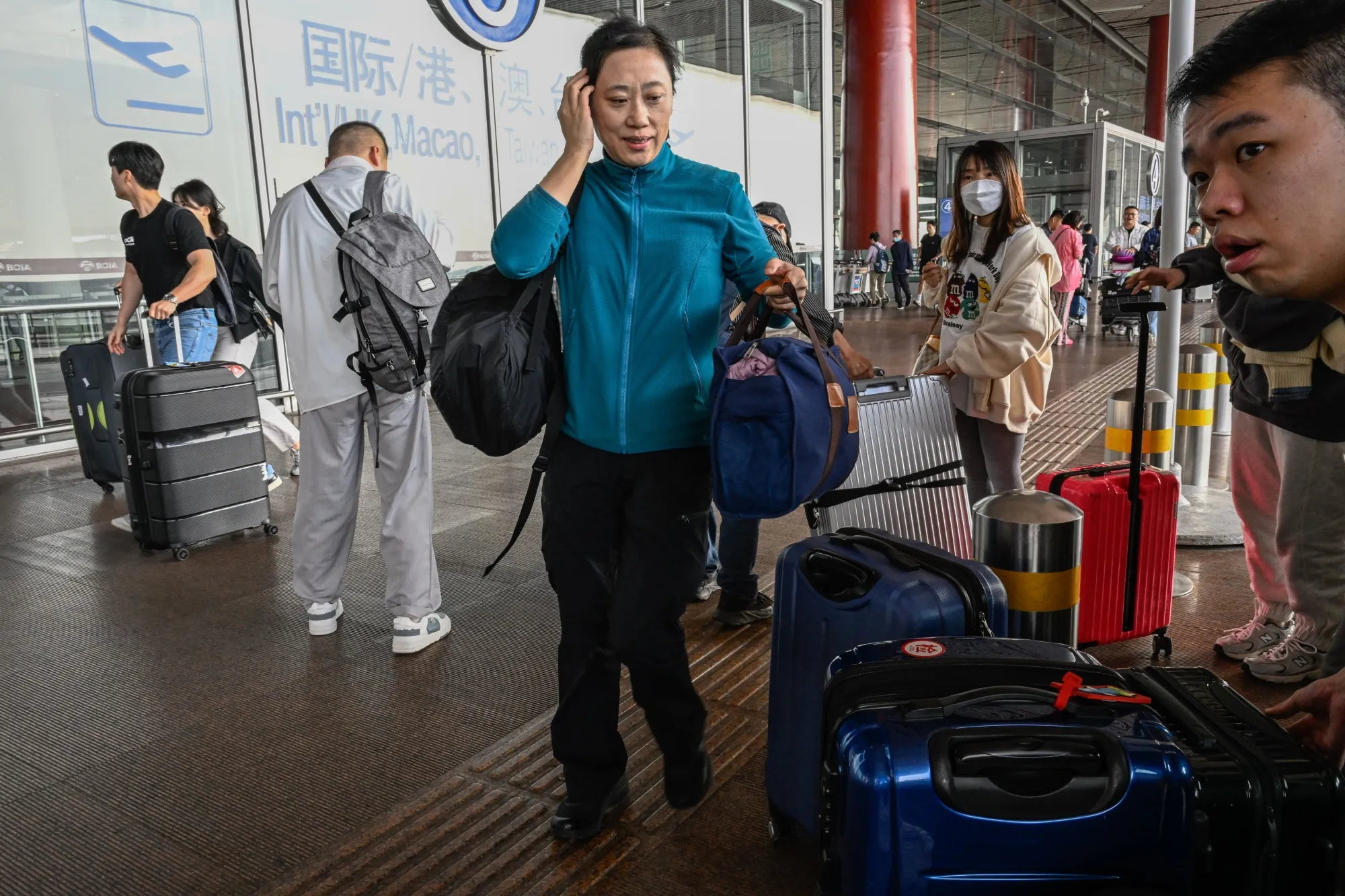 Travelers at Beijing Capital International Airport.