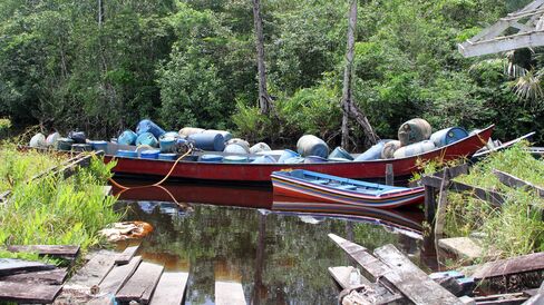 Motorboats ferry gasoline through the tributaries of the Orinoco River.