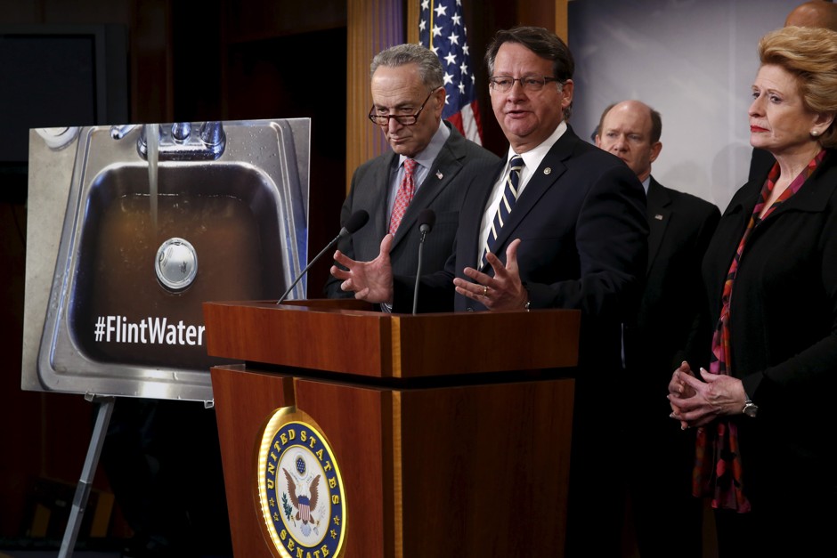 U.S. Senator Gary Peters (D-MI) (3rd R) addresses a news conference about potential legislation in response to the water crisis in Flint, Michigan, with Senator Chuck Schumer (D-NY) (L-R), Senator Chris Coons (D-DE) and Senator Debbie Stabenow (D-MI), at the U.S. Capitol in Washington January 28, 2016. 