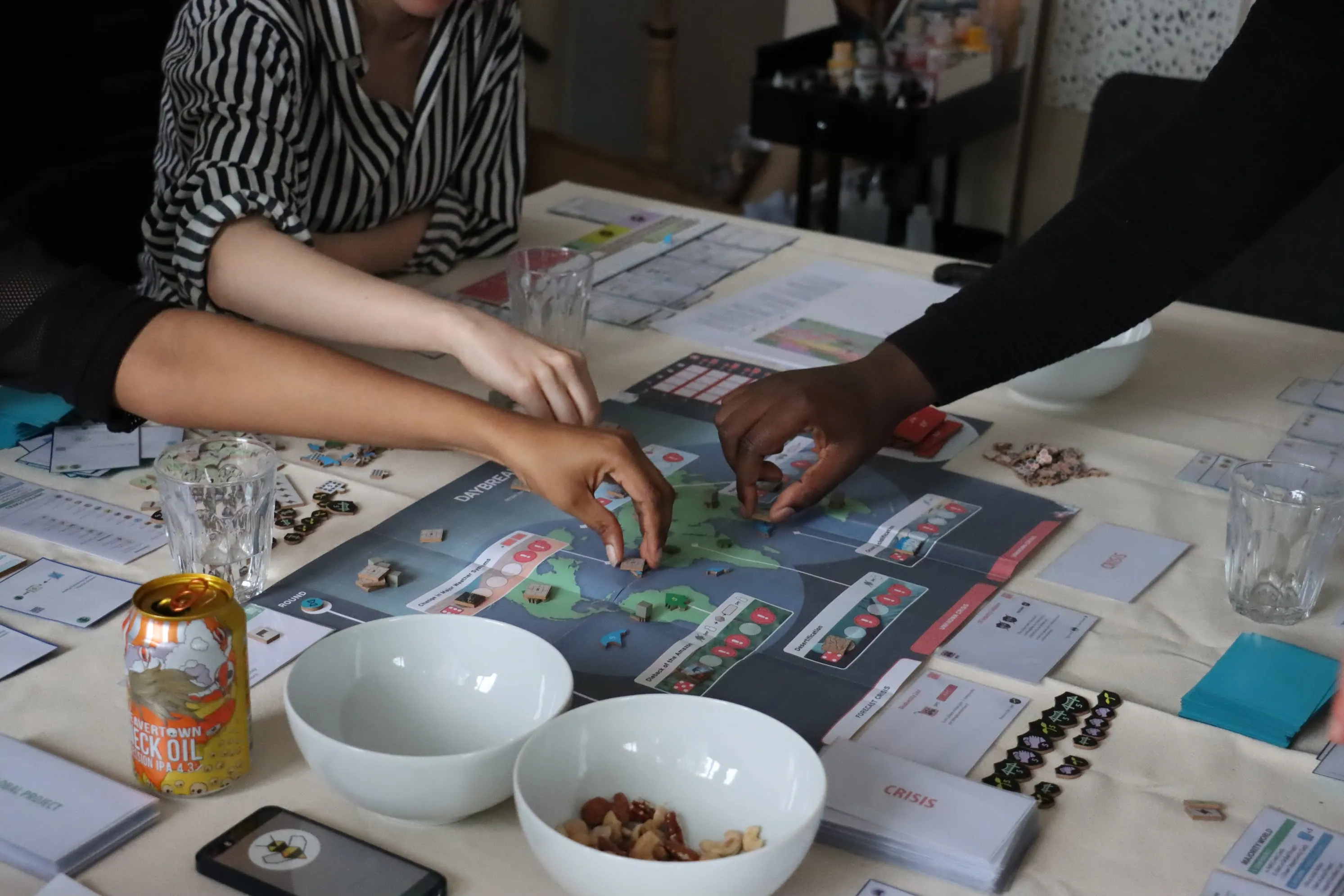 Players test out a beta version of Daybreak, a forthcoming board game focused on climate change.