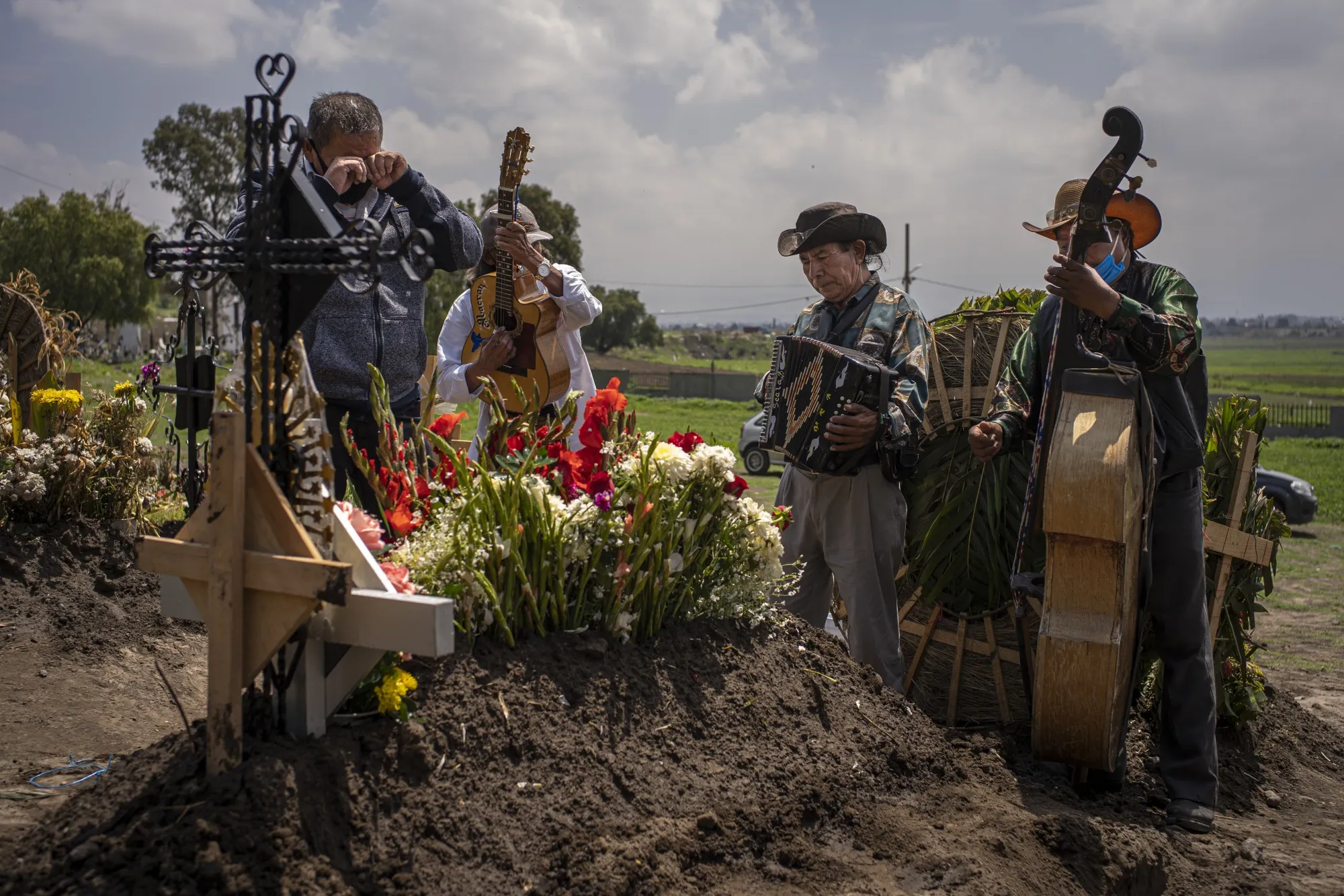 A person mourns&nbsp;during the burial of a relative who died from the coronavirus at San Miguel Xico cemetery in Mexico City.
