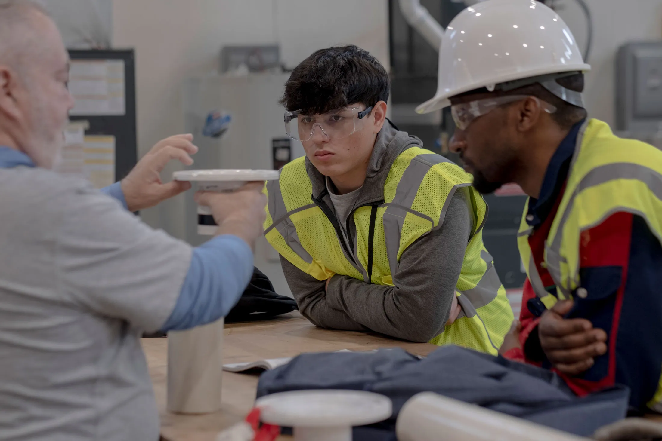Instructor Allen Jones instructs students Hugo Nufil Santos, left, and Jean Bosco Nshimiyimana, right, on pipes during a course on plumbing at the Clauson Center for Innovation and Skilled Trades at Anne Arundel Community College in Arnold, Md. on February 16, 2024.