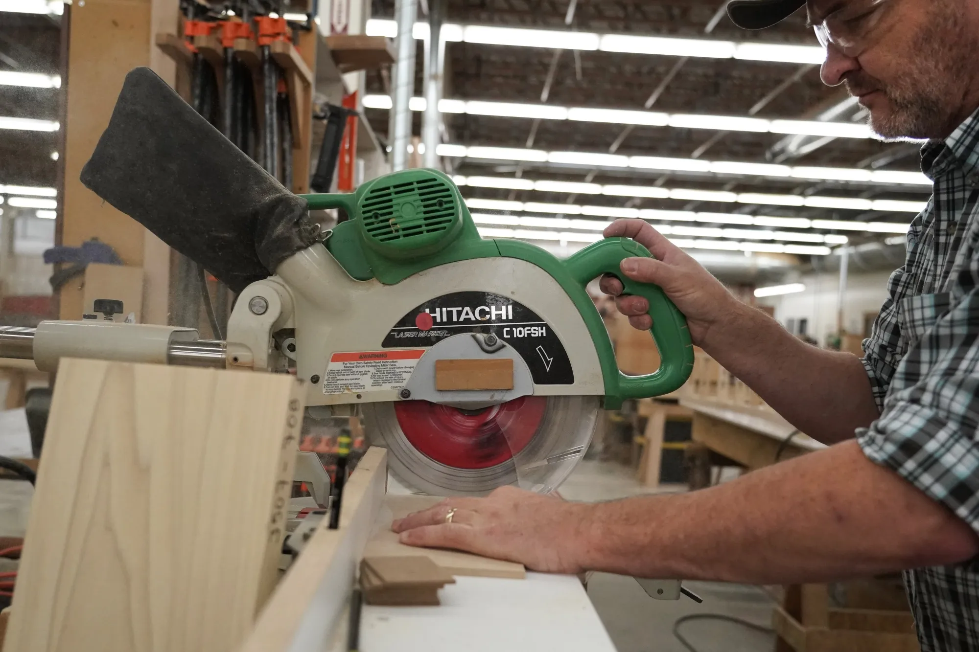 A worker cuts wood pieces at a JLR Contractors facility in Provo, Utah, US.