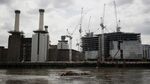 A boat passes the Battersea power station residential and retail development in London, on Aug. 7, 2015. Photographer: Simon Dawson/Bloomberg
