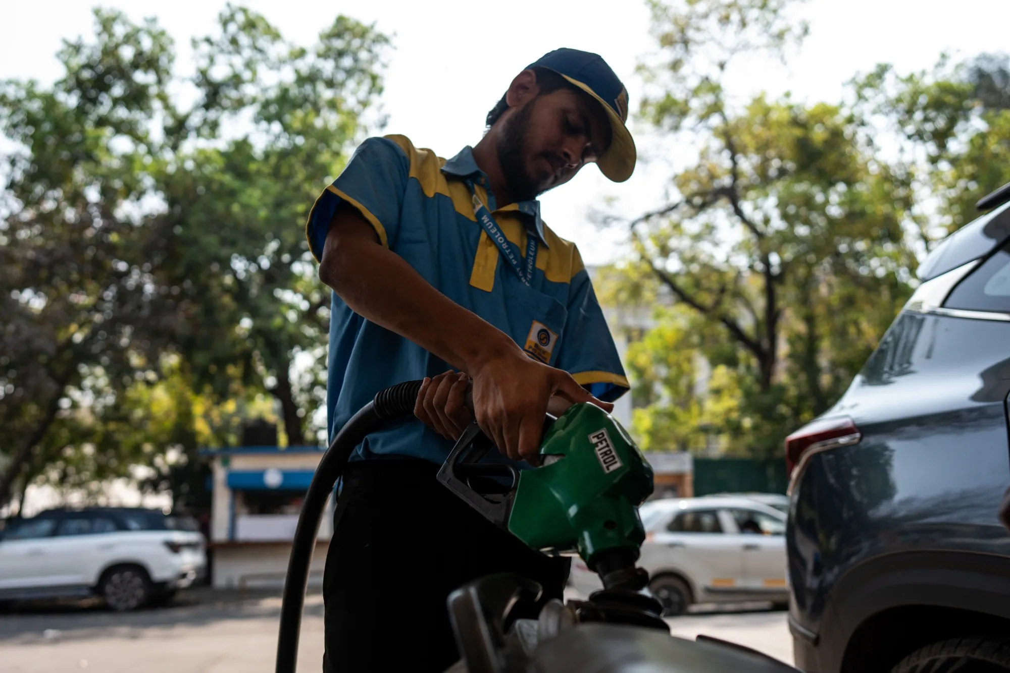 A petrol pump attendant fills fuel in a bike in New Delhi, India.