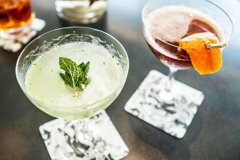 The mint colored "South Side" is made with 2oz Knickerbocker Gin, 1oz lime juice and 1.5oz of mint simple syrup. The cherry-colored "Blood & Sand" is a mix of 1oz Dewars scotch, 1oz Cherry Heering, 1oz Noilly Pratt sweet vermouth and 1oz blood orange juice. Each are served in etched vintage coupe glasses.