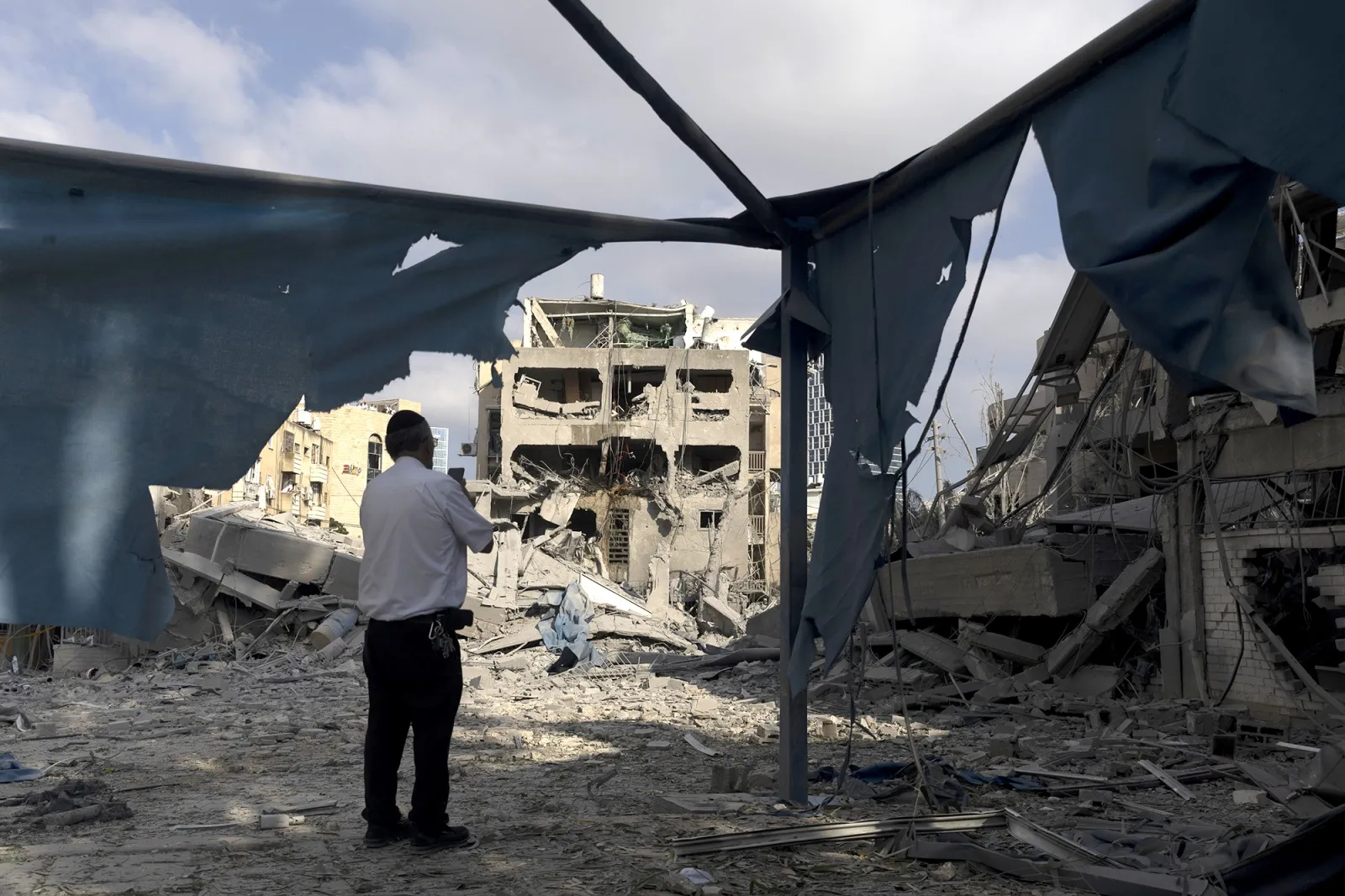 Un judío ultraortodoxo inspecciona los restos de un edificio gravemente dañado tras un ataque con misiles iraníes durante la noche del 16 de junio en Bnei Brak, Israel.