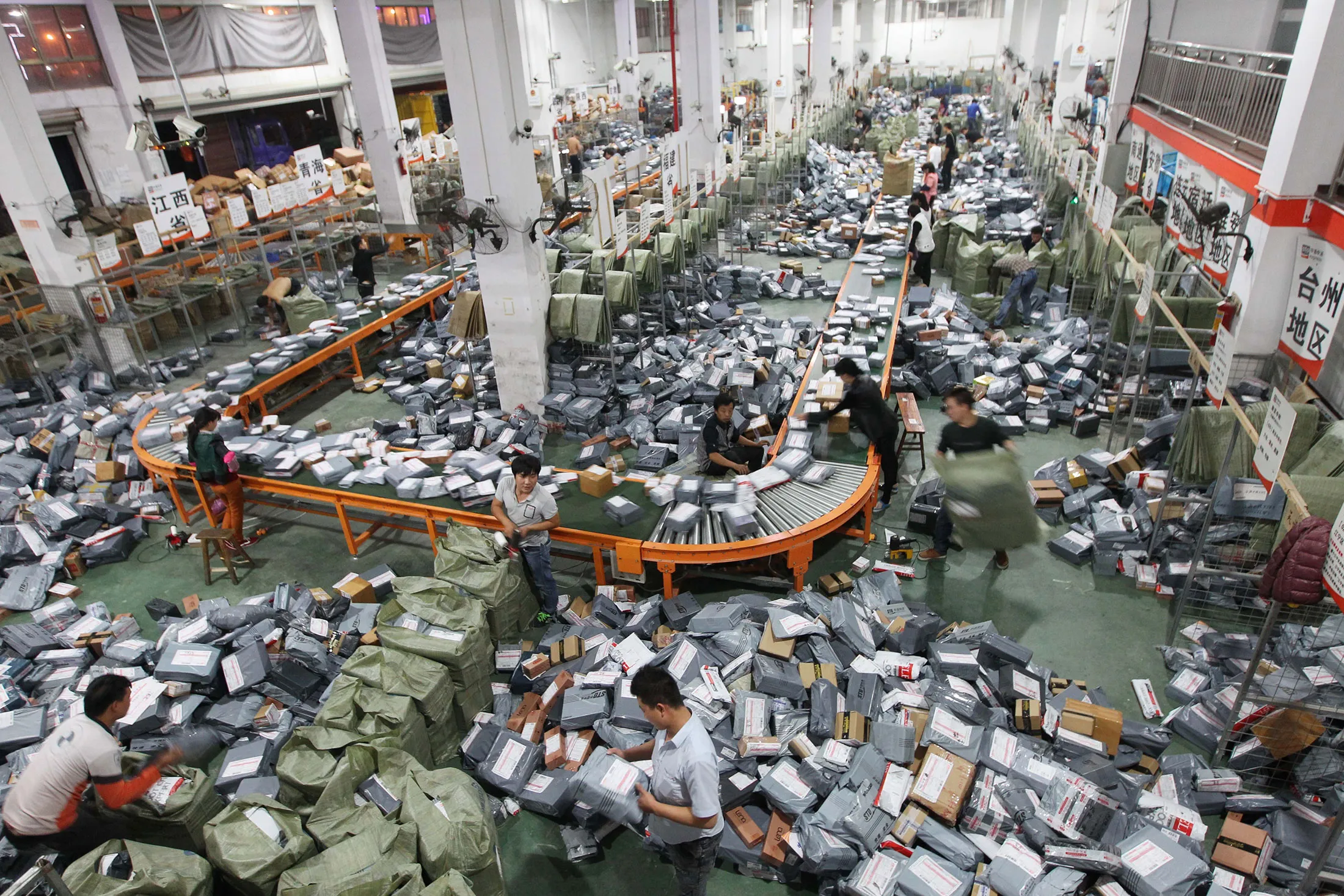 Workers deal with express packages on an assembly line on Singles' Day in Wenzhou, China.
