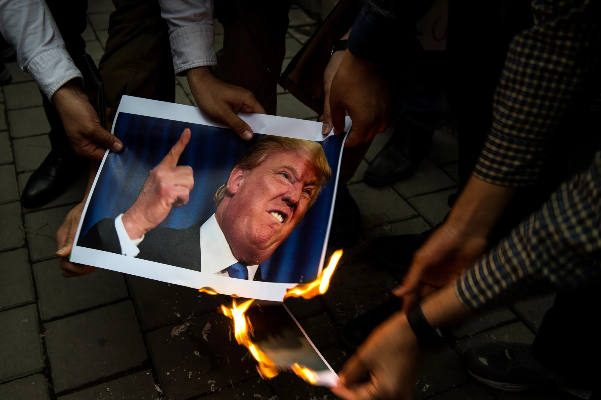 A photograph of U.S. President Donald Trump is set alight&nbsp;during an anti-U.S. demonstration&nbsp;in Tehran, on May 9.