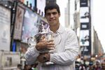 U.S. Open men's singles tennis champion Carlos Alcaraz poses in Times Square, Monday, Sept. 12, 2022, in New York. (AP Photo/Yuki Iwamura)