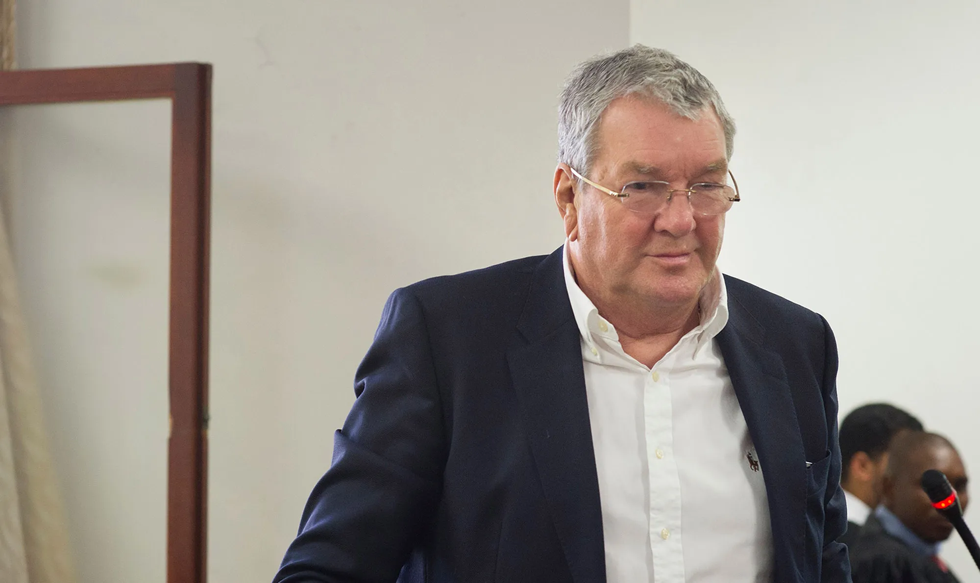 Guus Kouwenhoven walks out of the Magistrate’s Court in Cape Town in 2018.
