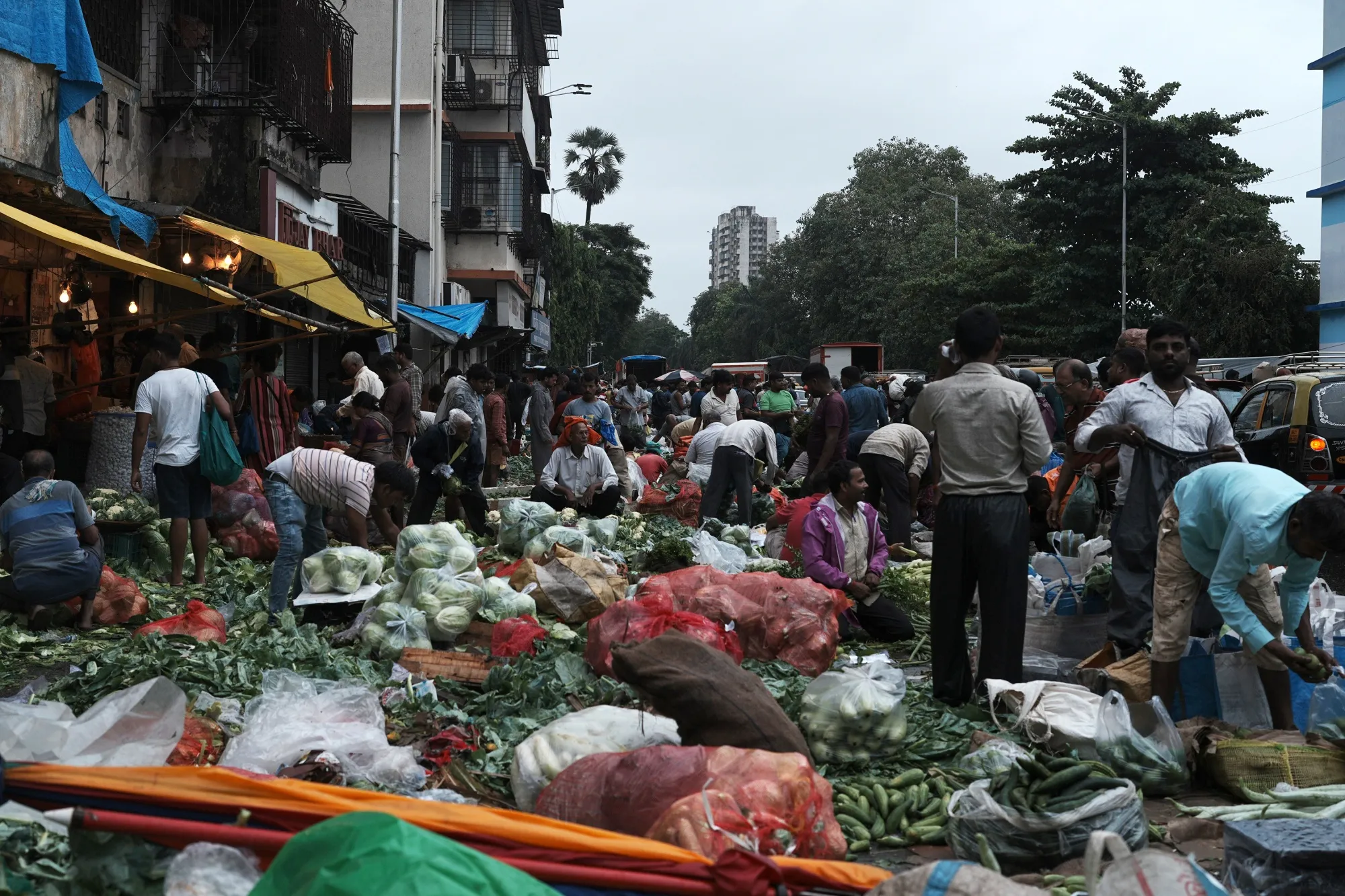 Street vendors sell vegetables at a market in Mumbai, India.