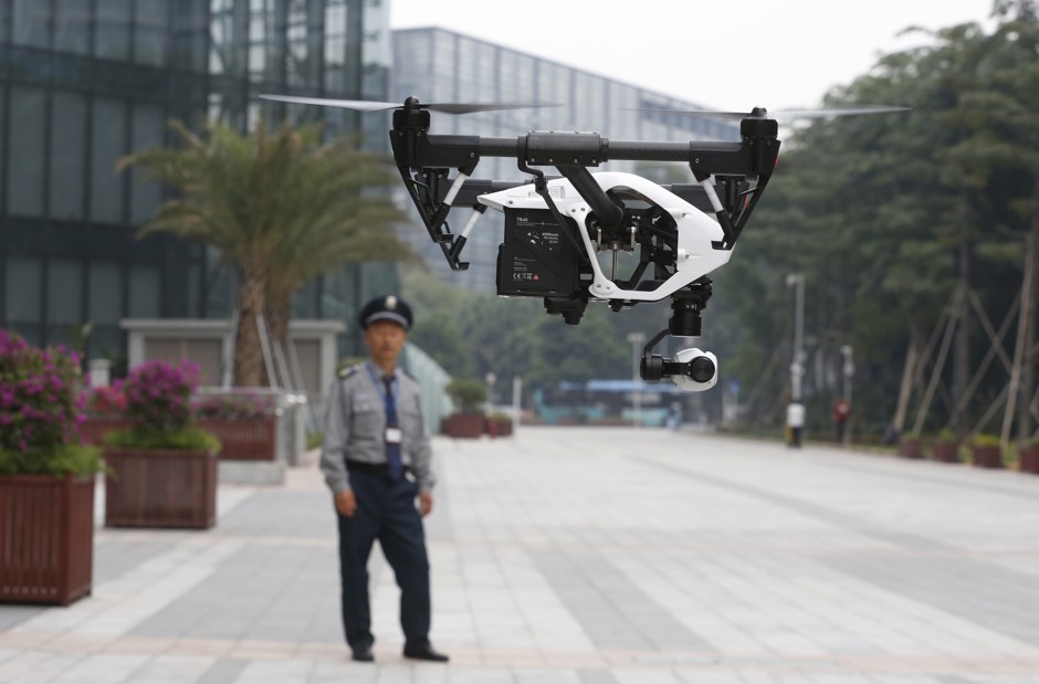 A security guard watches a demonstration by the Chinese company DJI, a leading supplier of civilian drones.