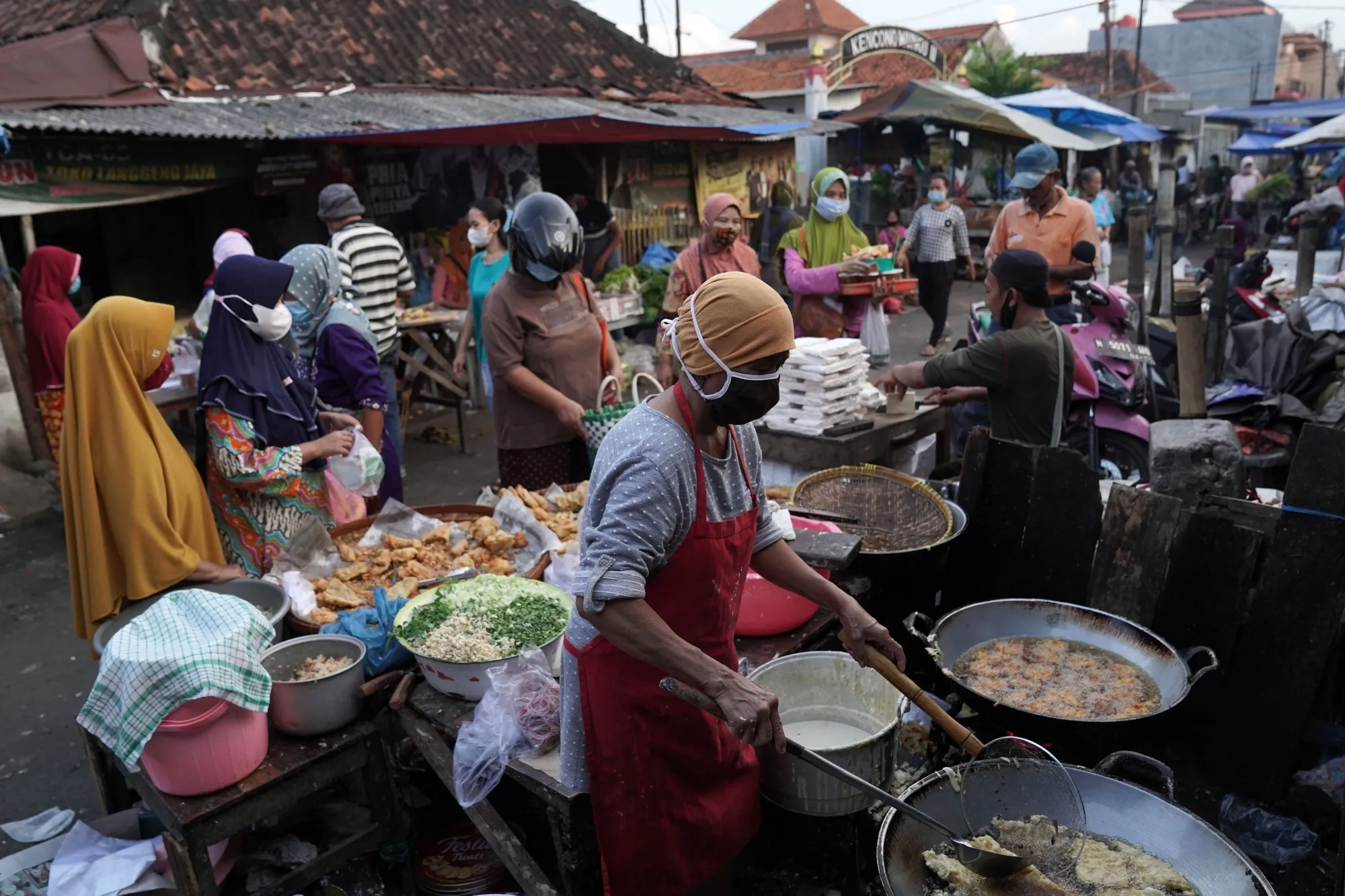 Shoppers at a food stall at Karangayu Market in Semarang, Central Java, Indonesia.