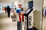 A customer adds credit to his mobile using a Globe Telecom Inc. GCash top-up machine in Taguig city, Metro Manila, the Philippines.&nbsp;