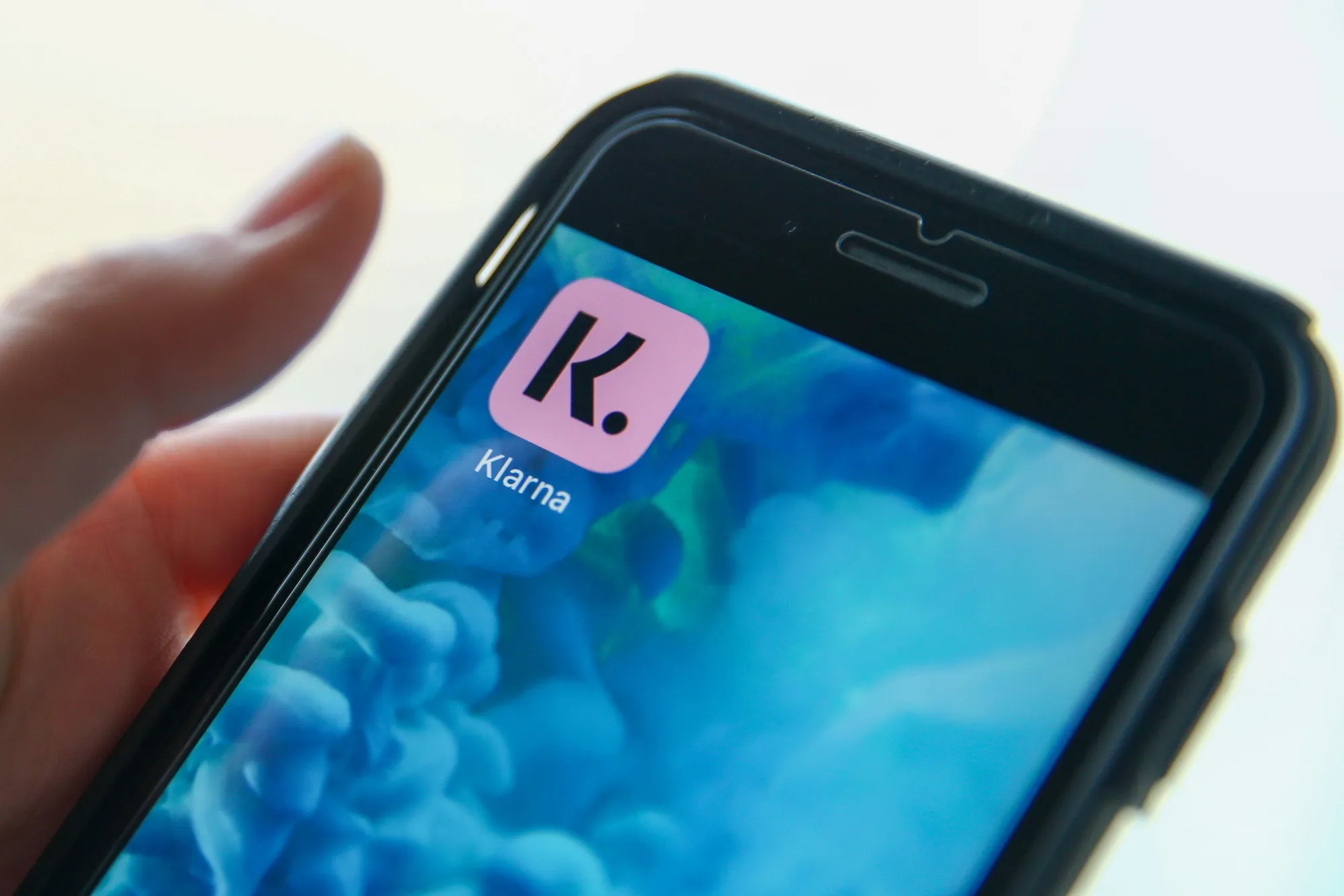 A Klarna app icon on a mobile phone.
