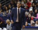 Then-Connecticut coach Kevin Ollie watches during the first half of an NCAA college basketball game in Storrs, Conn., Feb. 25, 2018. UConn announced Thursday, Sept. 15, 2022, it has agreed to pay former men’s basketball coach Kevin Ollie another $3.9 million to settle discrimination claims surrounding his 2018 firing. “I am grateful that we were able to reach agreement,” Ollie said in a statement Thursday “My time at UConn as a student athlete and coach is something I will always cherish. I am pleased that this matter is now fully and finally resolved.”(AP Photo/Jessica Hill, File)