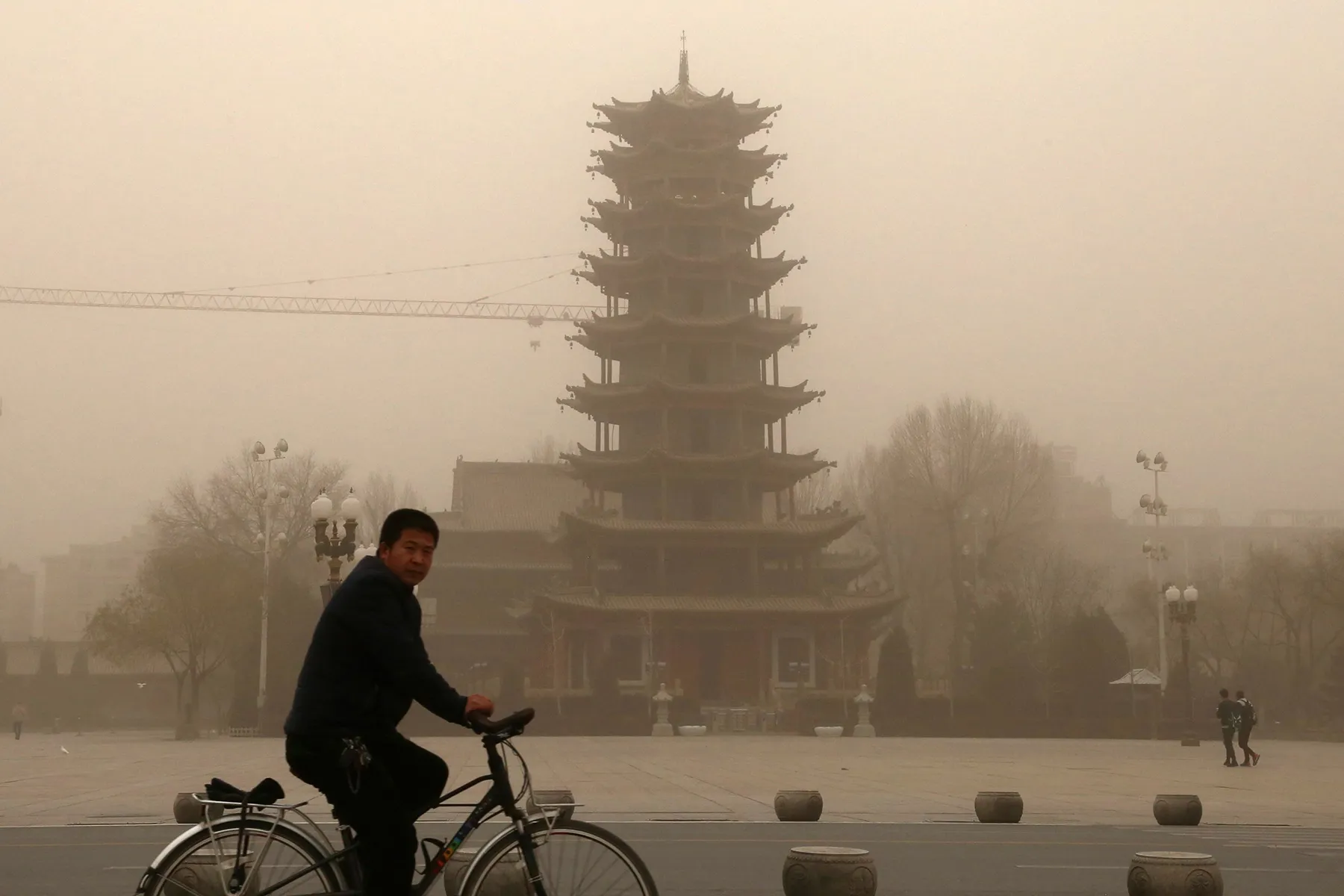 This photo taken on November 25, 2018 shows a cyclist riding in a sandstorm in Zhangye, in China's northwestern Gansu province. - A northwest Chinese city was engulfed by a massive sandstorm that sparked rural fires, forced traffic to slow down and prompted residents to cover their faces, according to state media. (Photo by - / AFP) / China OUT (Photo credit should read -/AFP/Getty Images)