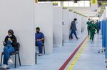People wait for their turn to be vaccinated in Kuwait City on Dec. 29, 2020.&nbsp;