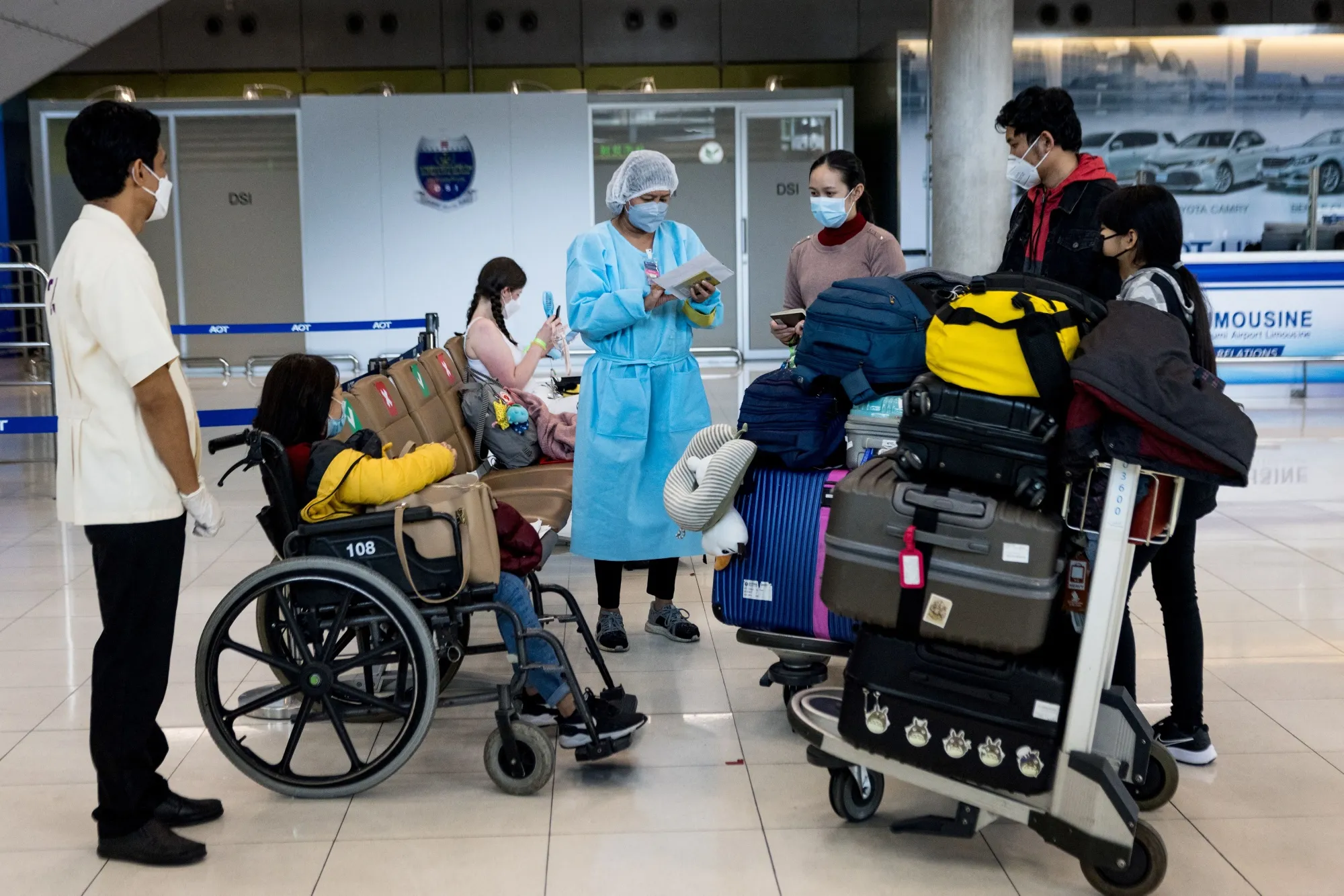 Passengers have their information checked by a hotel representative on arrival at Suvarnabhumi Airport in Bangkok on Feb. 1.