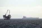 A tanker sits beyond an oil rig in Huntington Beach, California,&nbsp;on April 20.