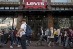 Pedestrians walk in front of the Levi Strauss &amp; Co. flagship store in San Francisco on&nbsp;March 18.&nbsp;