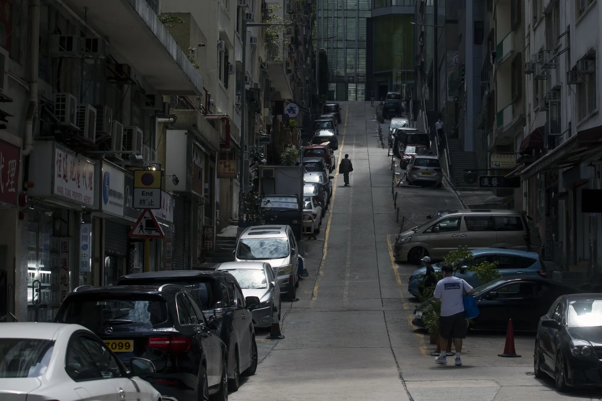 Pedestrians walk&nbsp;along a road in Hong Kong on March 1.