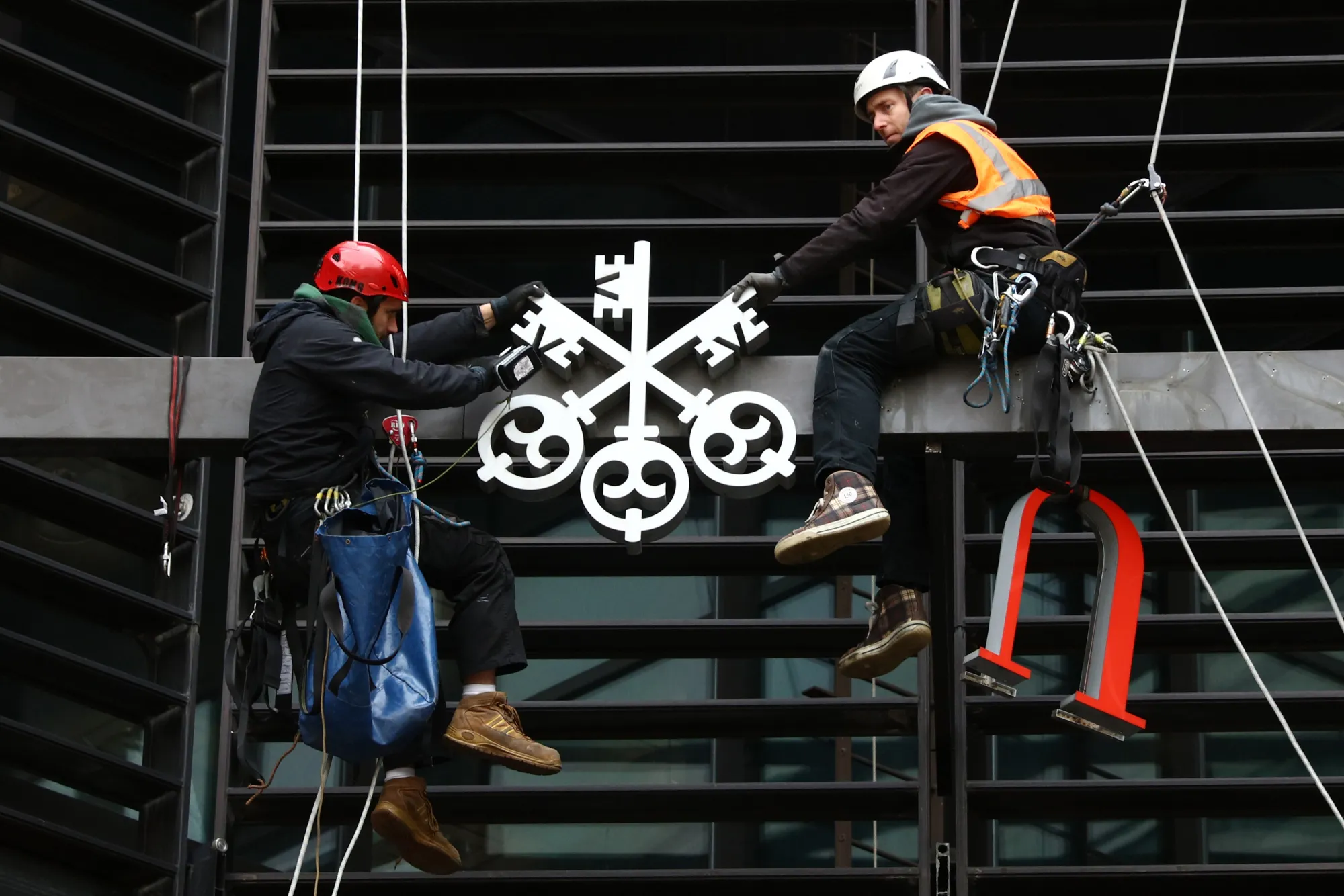 Workers Remove The UBS Group AG Logo From Their Offices At Broadgate Circle