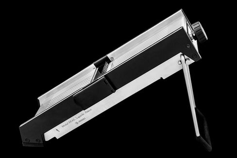Side view of the mandoline, with a rubberized kickstand that keeps it in place and a knob at the top for adjusting the thickness of slices.