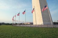 Wide angle view of the Washington Monument with American flags flying at the baseMore DC images: