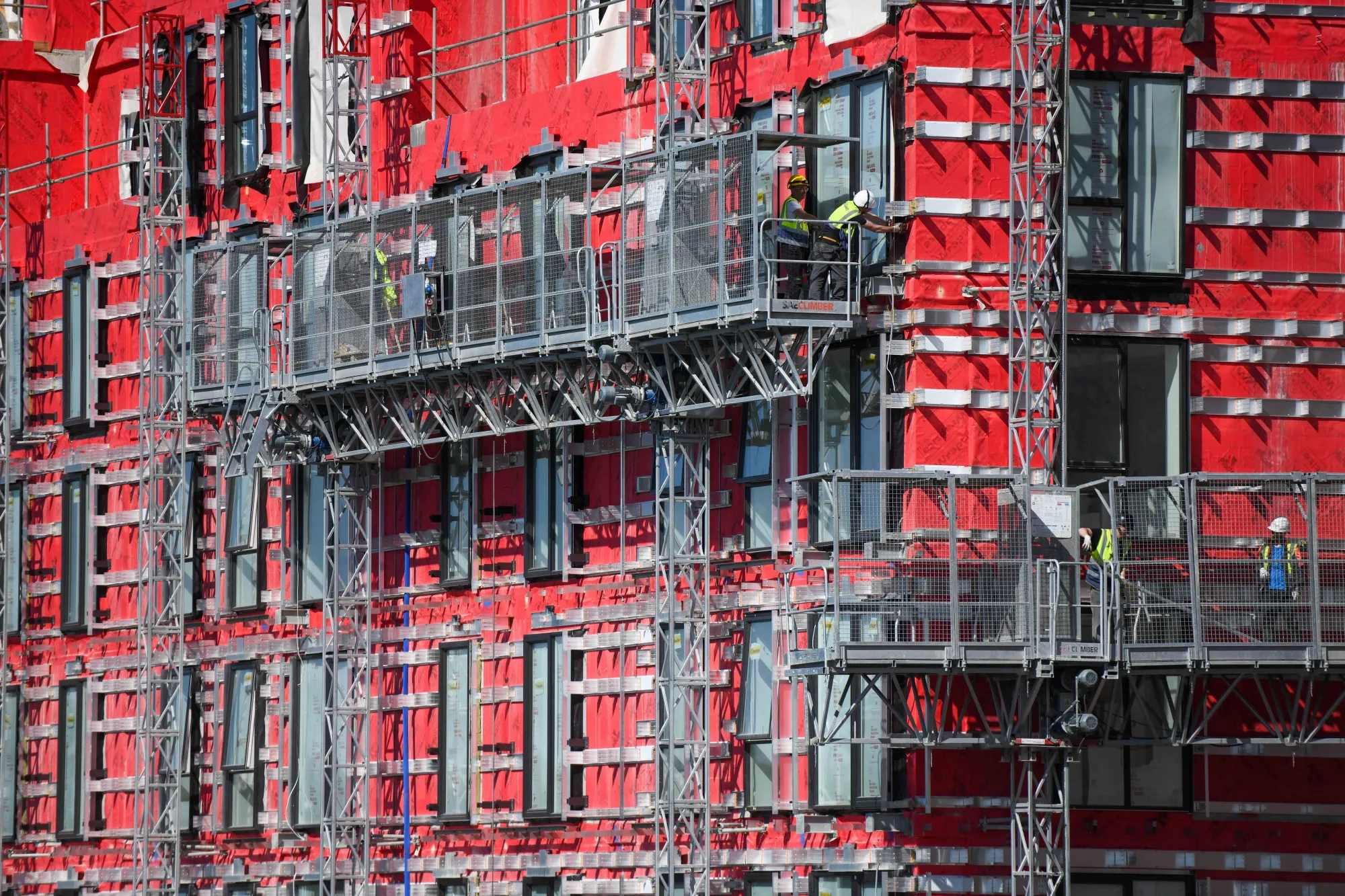 Builders work on a residential construction site.