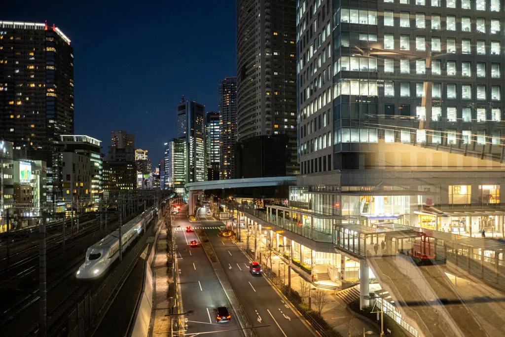 A shinkansen high-speed train travels past Hamamatsucho station in Tokyo.