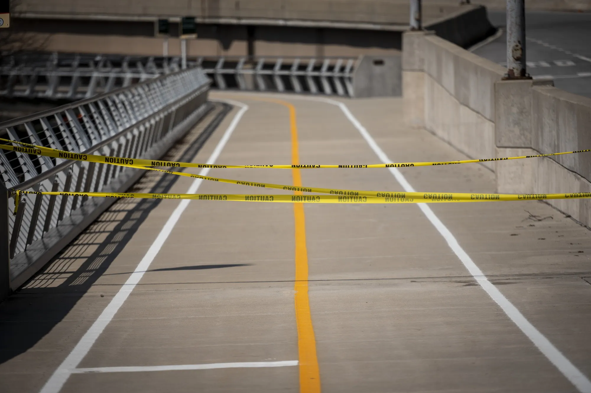 Caution tape block off a lakefront bike path in Chicago, Illinois, U.S., on Friday, April 3, 2020. The world's workers are reeling from the initial shock of the coronavirus recession, with job losses and welfare claims around the globe already running into the millions this week.