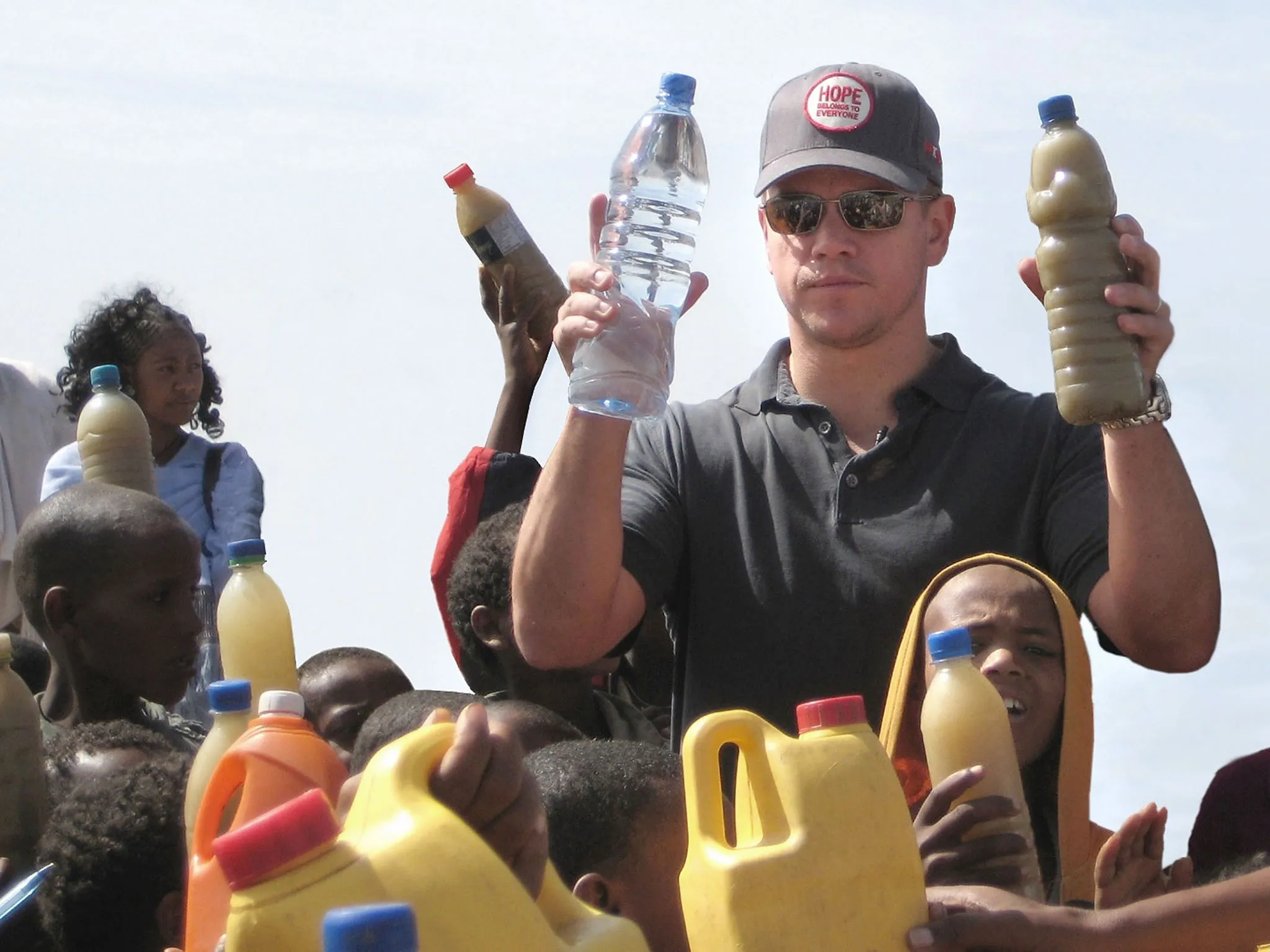 ONEXONE Foundation Ambassador actor Matt Damon visits a well in Ethiopia in 2009. In his right hand he holds a bottle of regular water, in his left is a bottle of dirty water the local children drink everyday.

