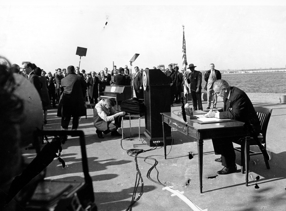 On October 3, 1965, President Lyndon Johnson signs a landmark immigration law.