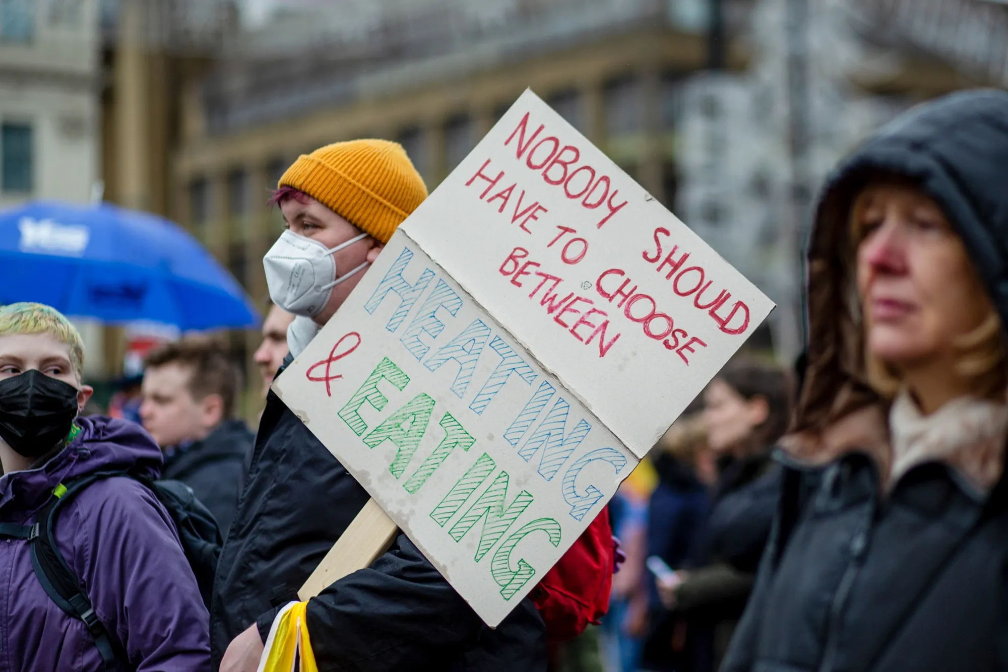 A protestor holds a sign during a 'current cost-of-living crisis' rally at George Square in Glasgow, U.K., on Feb. 12.