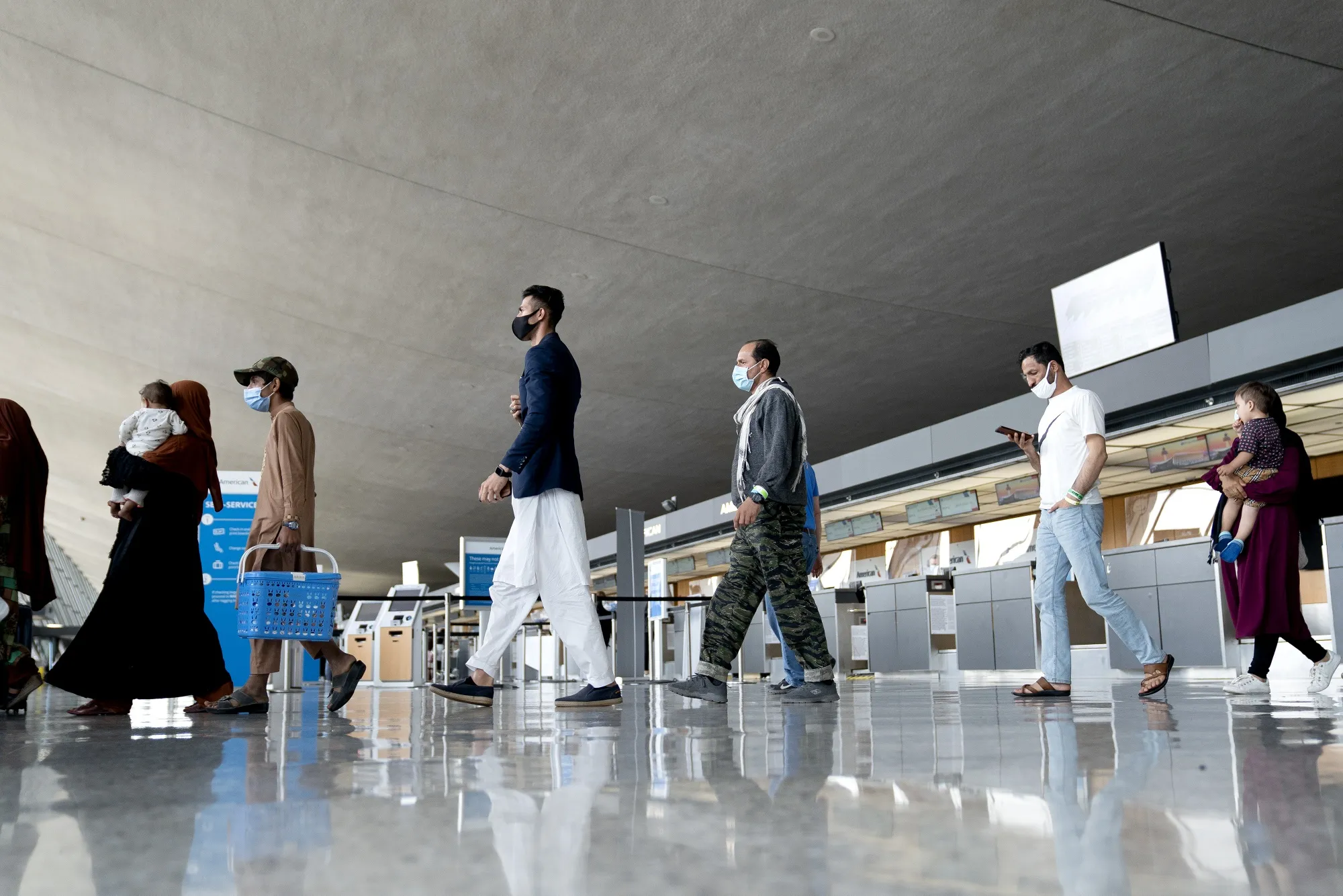 Refugees from Afghanistan walk through Washington Dulles International Airport in Dulles, Virginia.