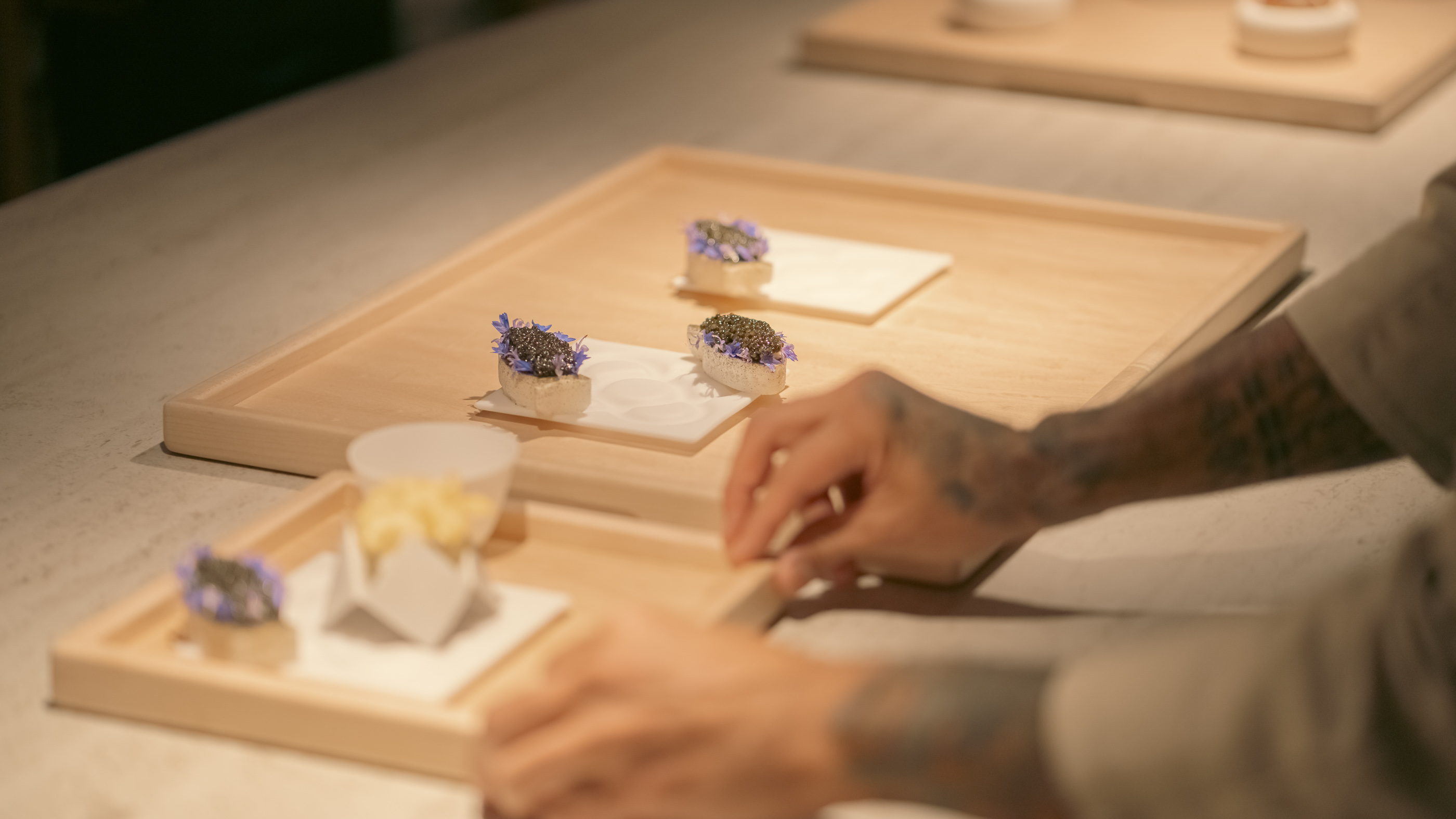 A chef at Somni plates almond-shaped canapes.